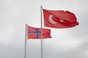 Turkish and Norwegian Flags on Flagpoles