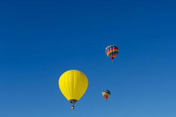 three hot air balloons in the blue sky