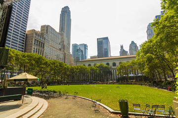 Empty tables and chairs at Bryant Park and New York Public Library main branch in the background on...