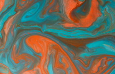 Fluid art with acrylic paint and ink in orange tones, black and gray and teal tones. colorful marble texture floor