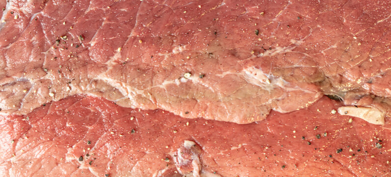 fresh raw meat of beef for steaks at butcher shop.