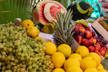 Open buffet full of delicious fruits with orange, grape, watermelon