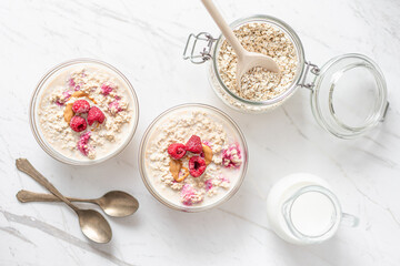 Obraz na płótnie Canvas Peanut and Raspberry Overnight Oats, Morning Porridge Breakfast, Diary Milk