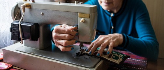 hands of a person with sewing machine