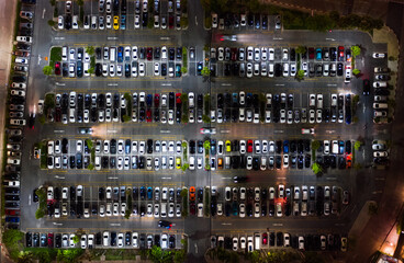 Car traffic, parking and leaving shopping mall's parking lot. Drone aerial top view. Transportation travel, city life, or shopping people lifestyle concept