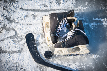 Details close up hockey scates on a frozen pond. Ice skating in nature at sunset in winter. Travel and sports