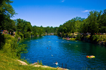 Cliff jumping in a rock quarry swimming hole on a hot summer afternoon.