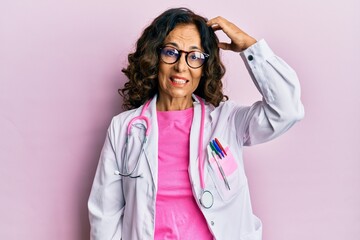 Middle age hispanic woman wearing doctor uniform and glasses confuse and wonder about question....
