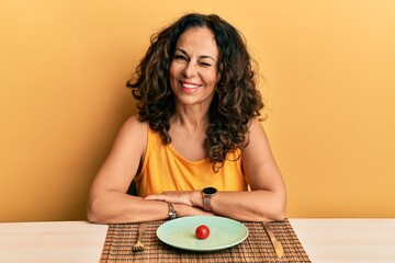 Beautiful middle age woman on a diet winking looking at the camera with sexy expression, cheerful...