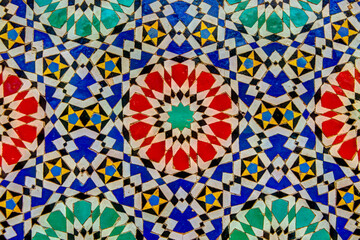 Intricate tile patterns, metal work and plaster carvings adorning  building exteriors in Fez Morocco
