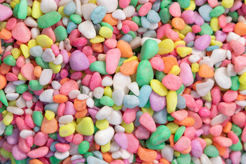 Mixed Collection Of Bright Multi Colored Tiny Decorative Stones Or Pebbles Of Various Shapes And Sizes Stacked. Used In Home Garden Backyard Fountain Decor And Aquarium. Wallpaper Or Background Choice