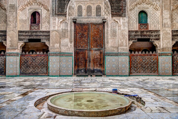 Intricate tile patterns, metal work and plaster carvings adorning  building exteriors in Fez Morocco