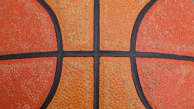The surface of a basketball sports orange ball.