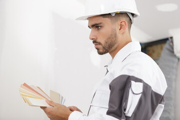 a male builder choosing swatches