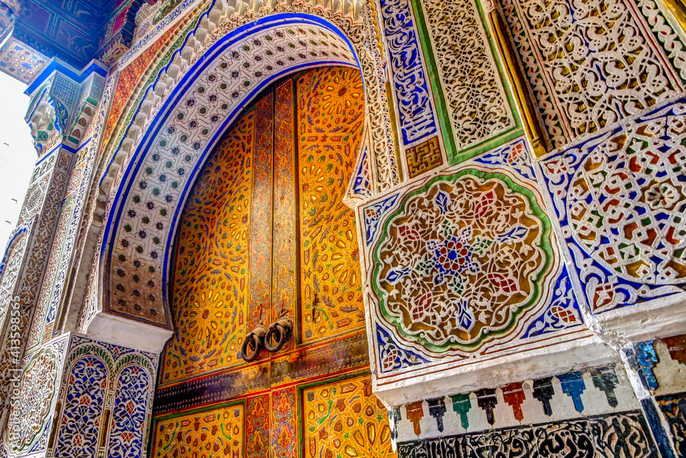 Sticker intricate tile patterns, metal work and plaster carvings adorning building exteriors in fez morocco