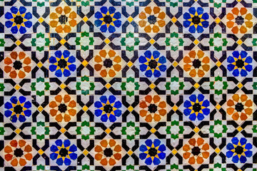 Intricate tile patterns, metal work and plaster carvings adorning  building exteriors in Fez Morocco