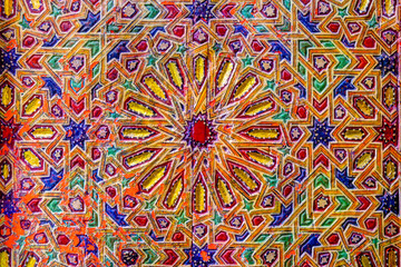 Intricate tile patterns, metal work and plaster carvings adorning  building exteriors in Fez Morocco