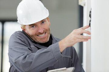 electrician installing socket in new house