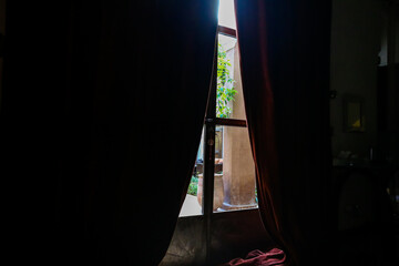 Looking out the curtain to the common area of the  Riad Laaroussa in Fes Morocco.