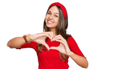 Young brunette woman wearing casual clothes smiling in love doing heart symbol shape with hands. romantic concept.