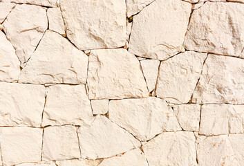 Texture of white yellow natural stone, limestone. Stone wall. Rural concept. Background