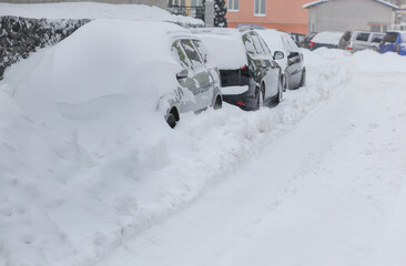 Parking in heavy snowfall. A car covered in snow. Snowstorm
