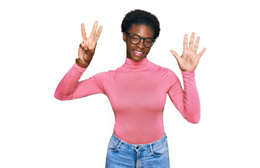 Young african american girl wearing casual clothes and glasses showing and pointing up with fingers number eight while smiling confident and happy.