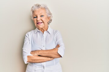 Senior grey-haired woman wearing casual clothes happy face smiling with crossed arms looking at the camera. positive person.