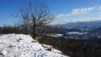 Fototapeta na wymiar the view from the snowy Ritterplatte (knight plate) at the Battert, a panorama path in Baden-Baden in the region Baden-Wuerttemberg, Germany