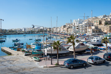 Fototapeta na wymiar Colorful Boats in Harbor of Marsaxlokk Malta at springtime