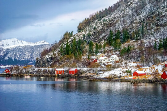 Norway, the village Ornes in December during the day. Typical wooden houses on the coastline