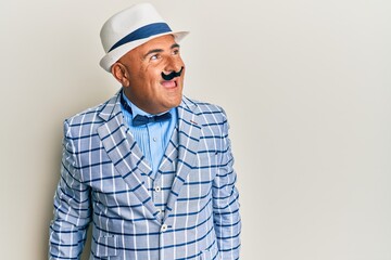 Mature middle east man with mustache wearing vintage and elegant fashion style looking to side, relax profile pose with natural face and confident smile.