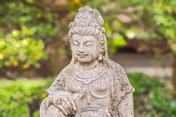 Fototapeta na wymiar Close up on the stone statue depicting the bust of the Japanese bodhisattva Monju Bosatsu symbolizing wisdom and intelligence in the Buddhist Togakuji temple of Tabata.