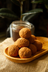 Healthy homemade paleo, hight protein chocolate energy balls with nuts anddates. Raw vegetarian sweets. Sugar free, gluten free.Tasty chocolates, confectionery concept