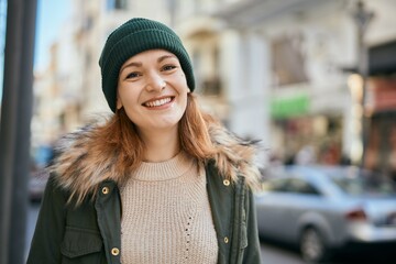 Fototapeta premium Young caucasian girl smiling happy standing at the city.
