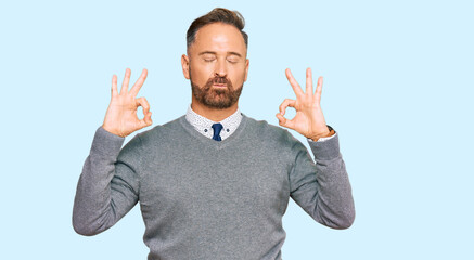 Handsome middle age man wearing business clothes relaxed and smiling with eyes closed doing meditation gesture with fingers. yoga concept.