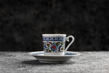 Turkish Coffee with traditional porcelain cup. Coffee presentation on gray background.