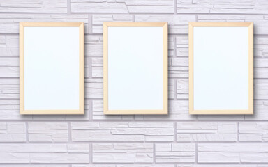 Obraz na płótnie Canvas three empty wooden photo frames on the wall.