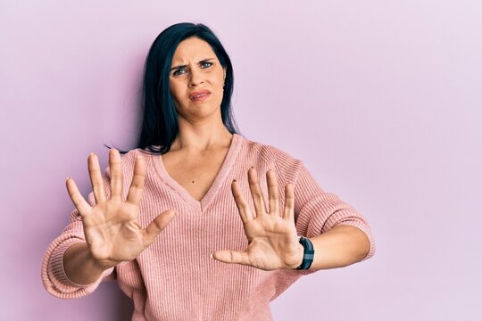 Young caucasian woman wearing casual clothes doing stop gesture with hands palms, angry and frustration expression