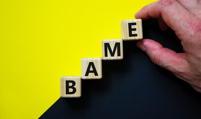 BAME symbol. Abbreviation BAME, black, asian and minority ethnic on wooden cubes. Beautiful yellow and black background. Copy space. Business and BAME, black, asian and minority ethnic concept.