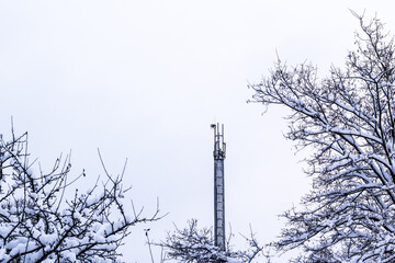 antenna in a winter city park. Winter city landscape. Snowfall