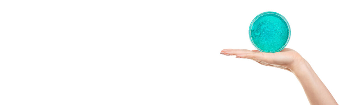 Hand with turquoise body scrab isolated on white background.
