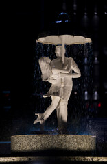 Fototapeta na wymiar Statue of a young couple in embrace at a steet junction