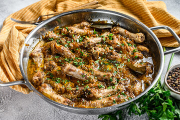 Indian Chicken Neck Curry Necks with vegetables. Gray background. Top view