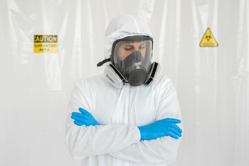 Man in protective suit, goggles, blue rubber gloves and respirator