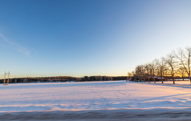 Beautiful nature landscape view on winter day. Field merging with blue sky and white clouds....