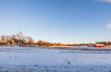 Beautiful nature landscape view on winter day. Field merging with blue sky and white clouds. Beautiful winter background. Sweden.