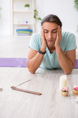 Young man during yoga session at home