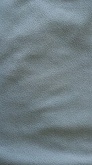 smoky gray material with short pile as a monochrome textured fabric background full frame with slight subtle folds on a fleecy surface, monochrome dark textile for making sportswear