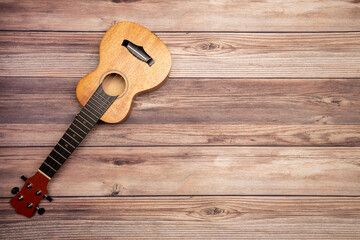 soprano ukulele on wooden background table top-down view room for copy